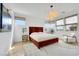 Bright bedroom with a large bed, neutral decor, and multiple windows at 513 Monarch Ridge Ct, North Las Vegas, NV 89084