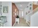 Bright entryway featuring tiled floors, decor, and a staircase, creating a welcoming first impression at 513 Monarch Ridge Ct, North Las Vegas, NV 89084