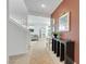 Bright entryway featuring tiled floors, decor, and a staircase, creating a welcoming first impression at 513 Monarch Ridge Ct, North Las Vegas, NV 89084
