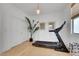 Exercise room featuring treadmill, weights, mirror and natural light at 513 Monarch Ridge Ct, North Las Vegas, NV 89084