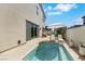 Backyard pool with an umbrella and lounge chairs, enclosed by a stucco wall with a sliding glass door at 513 Monarch Ridge Ct, North Las Vegas, NV 89084