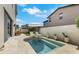 Private backyard pool area featuring a plunge pool, lounge chairs, umbrella, and lush landscaping at 513 Monarch Ridge Ct, North Las Vegas, NV 89084