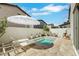 Backyard pool with an umbrella and lounge chairs, enclosed by a stucco wall with a sliding glass door at 513 Monarch Ridge Ct, North Las Vegas, NV 89084