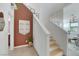 Bright interior shot of a modern staircase with light wood steps and earth tone accent wall at 513 Monarch Ridge Ct, North Las Vegas, NV 89084