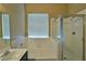 Bright bathroom features a shower over bath, vanity and natural light from the window at 5236 Ladyhawk Way, Las Vegas, NV 89118