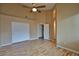 Spacious bedroom with hardwood floors, ceiling fan, and a large closet offers comfort and style at 5236 Ladyhawk Way, Las Vegas, NV 89118