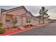 Street view of beige single-story home with a red curb and well-maintained landscaping at 5236 Ladyhawk Way, Las Vegas, NV 89118