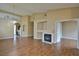Open-concept living room with a fireplace, hardwood floors, and neutral color palette at 5236 Ladyhawk Way, Las Vegas, NV 89118