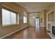 Living room featuring vaulted ceilings, hardwood floors, fireplace and large windows at 5236 Ladyhawk Way, Las Vegas, NV 89118