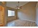 Main bedroom featuring hardwood floors, ceiling fan, and a window with blinds for natural light at 5236 Ladyhawk Way, Las Vegas, NV 89118