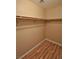 A walk-in closet featuring wood floors and shelving installed around the walls at 5236 Ladyhawk Way, Las Vegas, NV 89118