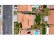 Aerial view of a landscaped backyard featuring a pergola-covered patio with seating, mature trees, and privacy hedges at 5609 Red Bluff Dr, Las Vegas, NV 89130