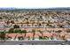 Neighborhood aerial view of homes with red-tiled roofs with beautiful city views and well-maintained streets at 5609 Red Bluff Dr, Las Vegas, NV 89130