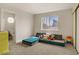 Bedroom with neutral carpet featuring a blue and gray modular sofa with plenty of room for activities at 5609 Red Bluff Dr, Las Vegas, NV 89130
