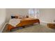 Bedroom with neutral walls and a large window, featuring a bed with orange bedding at 5609 Red Bluff Dr, Las Vegas, NV 89130