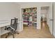 Well-organized walk-in closet with shelving, hanging rods, and a view into the adjacent office at 5609 Red Bluff Dr, Las Vegas, NV 89130