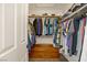 Walk-in closet with shelving, hanging racks filled with clothing, and a wood chest at 5609 Red Bluff Dr, Las Vegas, NV 89130