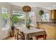 Bright dining area featuring a table set for six, large windows, and backyard views at 5609 Red Bluff Dr, Las Vegas, NV 89130