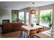 Inviting dining area with hardwood floors, large windows, and a view to the backyard at 5609 Red Bluff Dr, Las Vegas, NV 89130