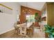 Bright dining room with vaulted ceilings, stylish chandelier, and large window at 5609 Red Bluff Dr, Las Vegas, NV 89130