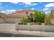 Charming single-Gathering home featuring a well-manicured front yard, a three-car garage, and a red tile roof at 5609 Red Bluff Dr, Las Vegas, NV 89130