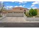 Charming single-Gathering home featuring a well-manicured front yard, a three-car garage, and a red tile roof at 5609 Red Bluff Dr, Las Vegas, NV 89130