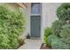Welcoming front entrance with a green door, lush greenery, and a tiled walkway at 5609 Red Bluff Dr, Las Vegas, NV 89130