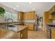 Well-lit kitchen showcasing granite countertops, wood cabinetry, and modern appliances at 5609 Red Bluff Dr, Las Vegas, NV 89130