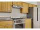 Kitchen with stainless steel oven, hood, and refrigerator with wood cabinets at 5609 Red Bluff Dr, Las Vegas, NV 89130