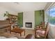 The living room includes a fireplace, hardwood floors, piano and bookshelves at 5609 Red Bluff Dr, Las Vegas, NV 89130
