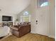 Bright living room featuring vaulted ceilings, arched windows, and comfortable seating at 5609 Red Bluff Dr, Las Vegas, NV 89130