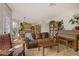 Cozy living room with a large leather couch and piano, adjacent to the kitchen at 5609 Red Bluff Dr, Las Vegas, NV 89130