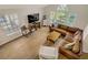 Open living room with large windows, a leather sectional sofa, and hardwood floors at 5609 Red Bluff Dr, Las Vegas, NV 89130