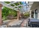 Outdoor patio area with a pergola, string lights, brick pillars, and a dining set for outdoor entertaining at 5609 Red Bluff Dr, Las Vegas, NV 89130