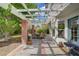 Outdoor patio area featuring a pergola, string lights, brick pillars, and an outdoor dining table at 5609 Red Bluff Dr, Las Vegas, NV 89130