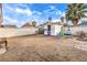 Spacious backyard with shed, mature trees, fire pit, and ample space for outdoor activities at 5809 Robin Ln, Las Vegas, NV 89108