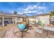 Backyard features unique swing chairs, a fire pit, and ample space for outdoor enjoyment at 5809 Robin Ln, Las Vegas, NV 89108