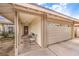 Cozy covered porch area with seating leading to a two-car garage at 5809 Robin Ln, Las Vegas, NV 89108