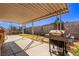 A covered patio with a grill in the backyard, providing ample shade and space for outdoor activities at 5813 Halifax Ave, Las Vegas, NV 89107