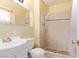 Bathroom featuring tiled walls, single sink vanity and a walk-in shower at 5813 Halifax Ave, Las Vegas, NV 89107