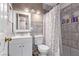 Modern bathroom featuring tiled shower, storage niche, updated vanity, and modern lighting at 5813 Halifax Ave, Las Vegas, NV 89107