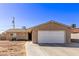 Single story home with a two-car garage and low maintenance xeriscape front yard at 5813 Halifax Ave, Las Vegas, NV 89107