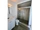 Modern bathroom featuring a glass-enclosed shower with decorative tile and white vanity at 6212 Burgundy Way, Las Vegas, NV 89107