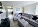 Cozy living room featuring a comfortable gray sectional sofa and tile flooring at 6212 Burgundy Way, Las Vegas, NV 89107
