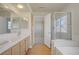 Bathroom featuring tile countertops, double sinks, tub and glass shower at 6332 Sierra Pines Ct, Las Vegas, NV 89130