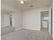 Bedroom with carpet, ceiling fan, and a glimpse into the laundry room, showcasing seamless connectivity at 6332 Sierra Pines Ct, Las Vegas, NV 89130