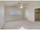 Spacious carpeted bedroom with ceiling fan, ensuite bathroom and window at 6332 Sierra Pines Ct, Las Vegas, NV 89130