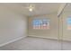 Bright bedroom featuring carpet, natural light from the window, and ample storage with mirrored closet doors at 6332 Sierra Pines Ct, Las Vegas, NV 89130