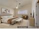 Staged bedroom with a bed, ceiling fan, neutral colors, and a window, creating a welcoming and relaxing ambiance at 6332 Sierra Pines Ct, Las Vegas, NV 89130