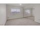 Cozy bedroom with carpet, a large window offering natural light, and mirrored closet doors for added space at 6332 Sierra Pines Ct, Las Vegas, NV 89130
